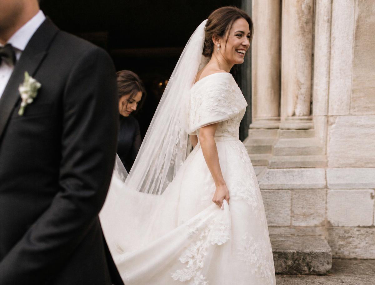 A Dilwien Bridal bride in an ivory wedding dress leaving a European church